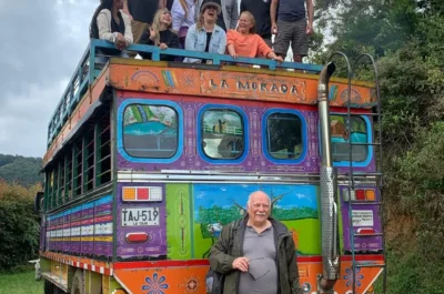 Colombian chiva with foreigners onboard, an immersive cultural experience for Spanish students.
